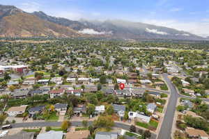 Aerial view of property's location with a mountain backdrop and nearby suburban area
