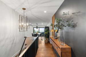 Foyer with wood finished floors and recessed lighting