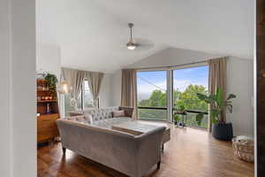 Living area featuring breathtaking view, wood finished floors, lofted ceiling, and a ceiling fan