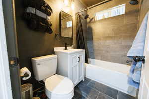 Bathroom featuring shower / bath combo with shower curtain and vanity
