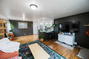 Living room featuring a textured ceiling and wood finished floors
