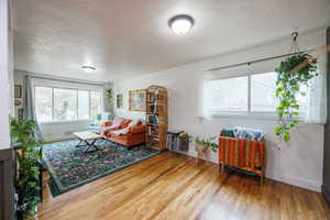 Living area featuring a textured ceiling and light wood finished floors
