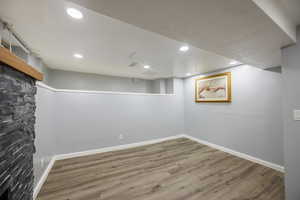 Finished basement featuring wood finished floors and recessed lighting