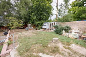 Fenced backyard featuring an outdoor structure and exterior structure