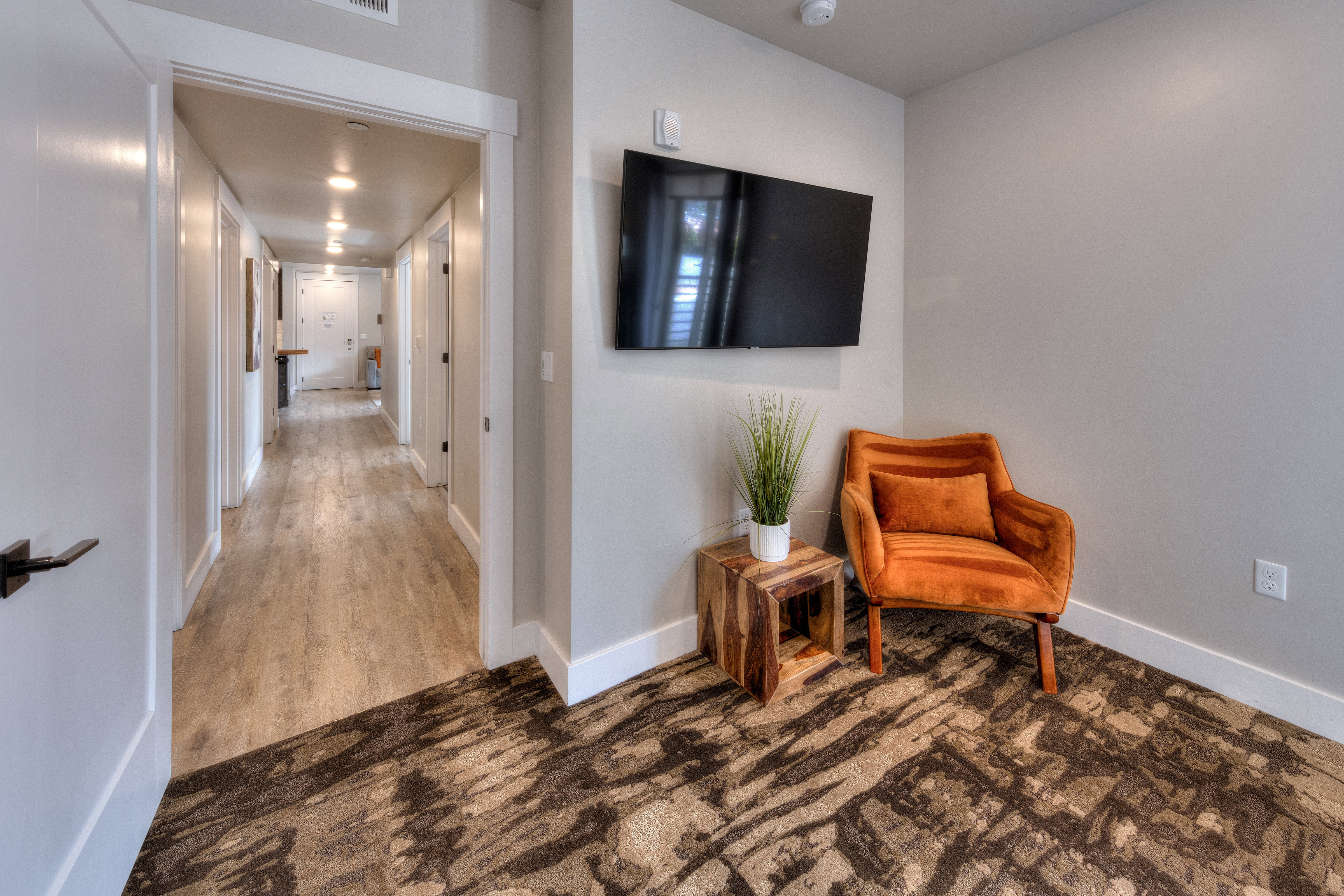 Sitting room with wood finished floors and carpet