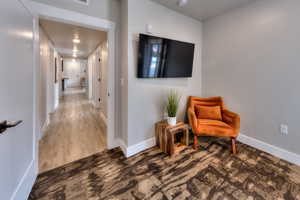 Sitting room with wood finished floors and carpet