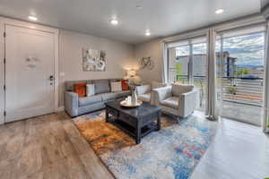 Living room with wood finished floors and recessed lighting