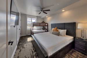 Bedroom with a ceiling fan, recessed lighting, and dark colored carpet