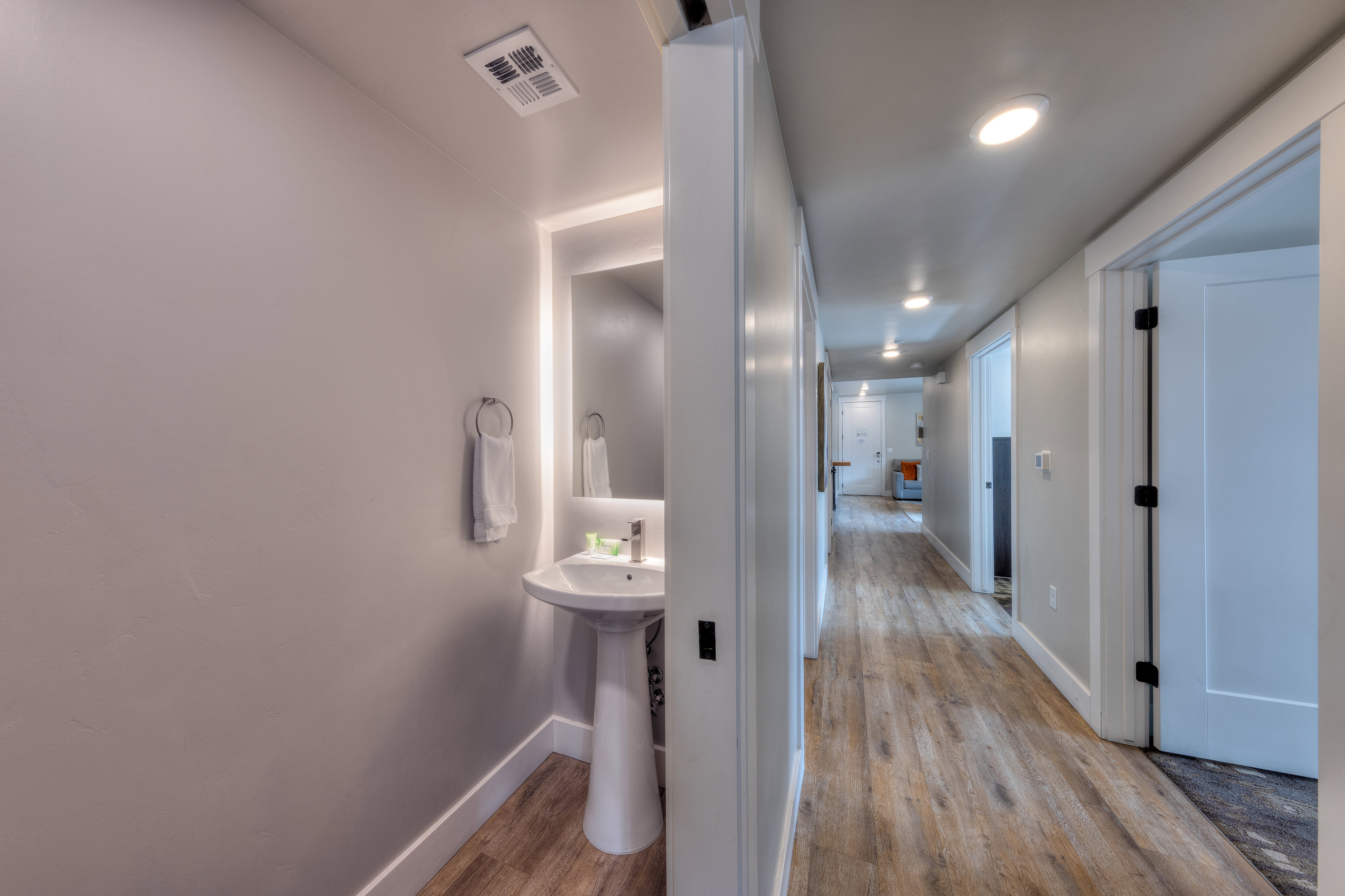 Corridor with light wood-style flooring and recessed lighting