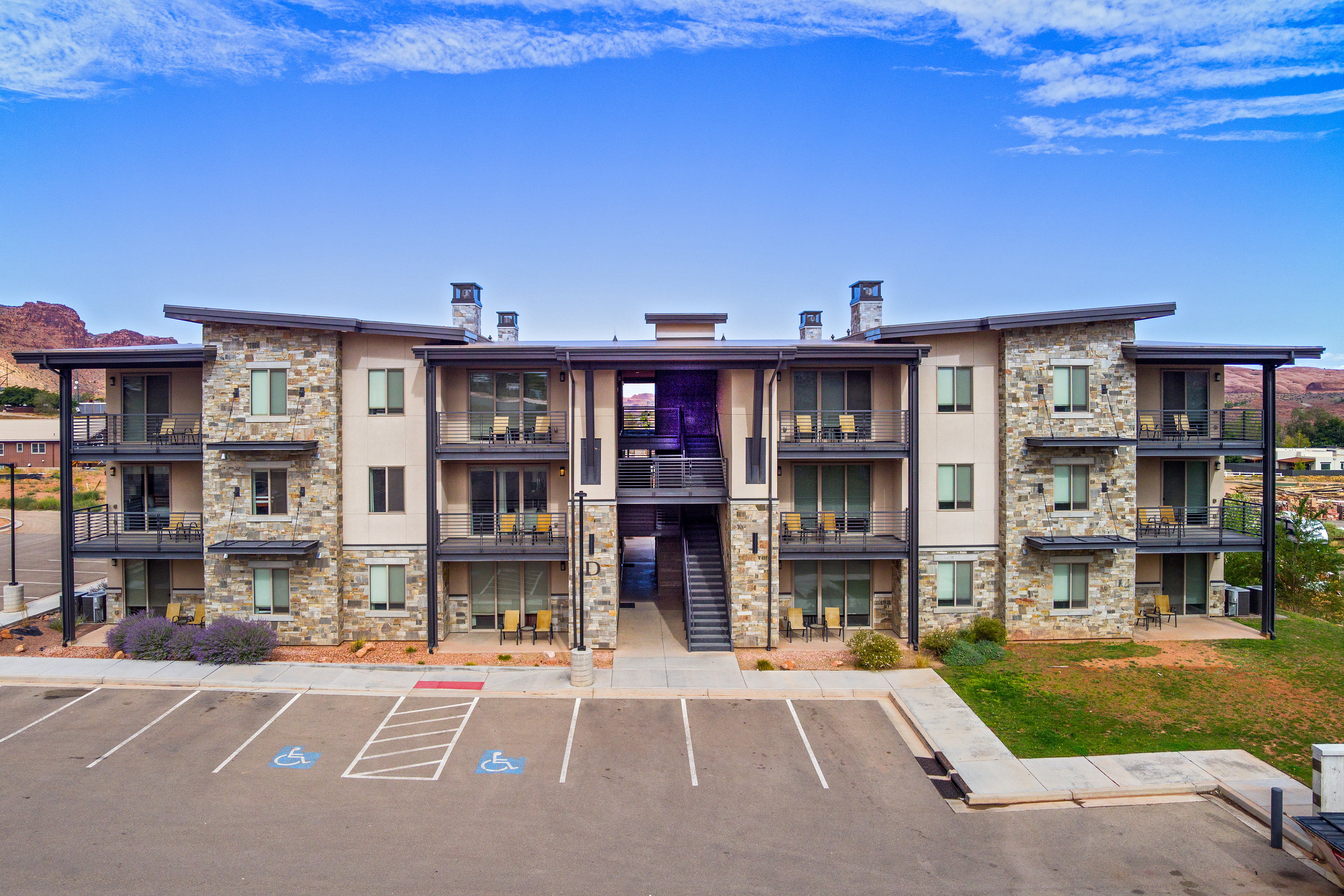View of building exterior featuring uncovered parking