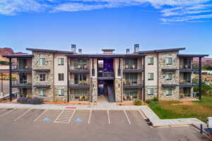 View of building exterior featuring uncovered parking