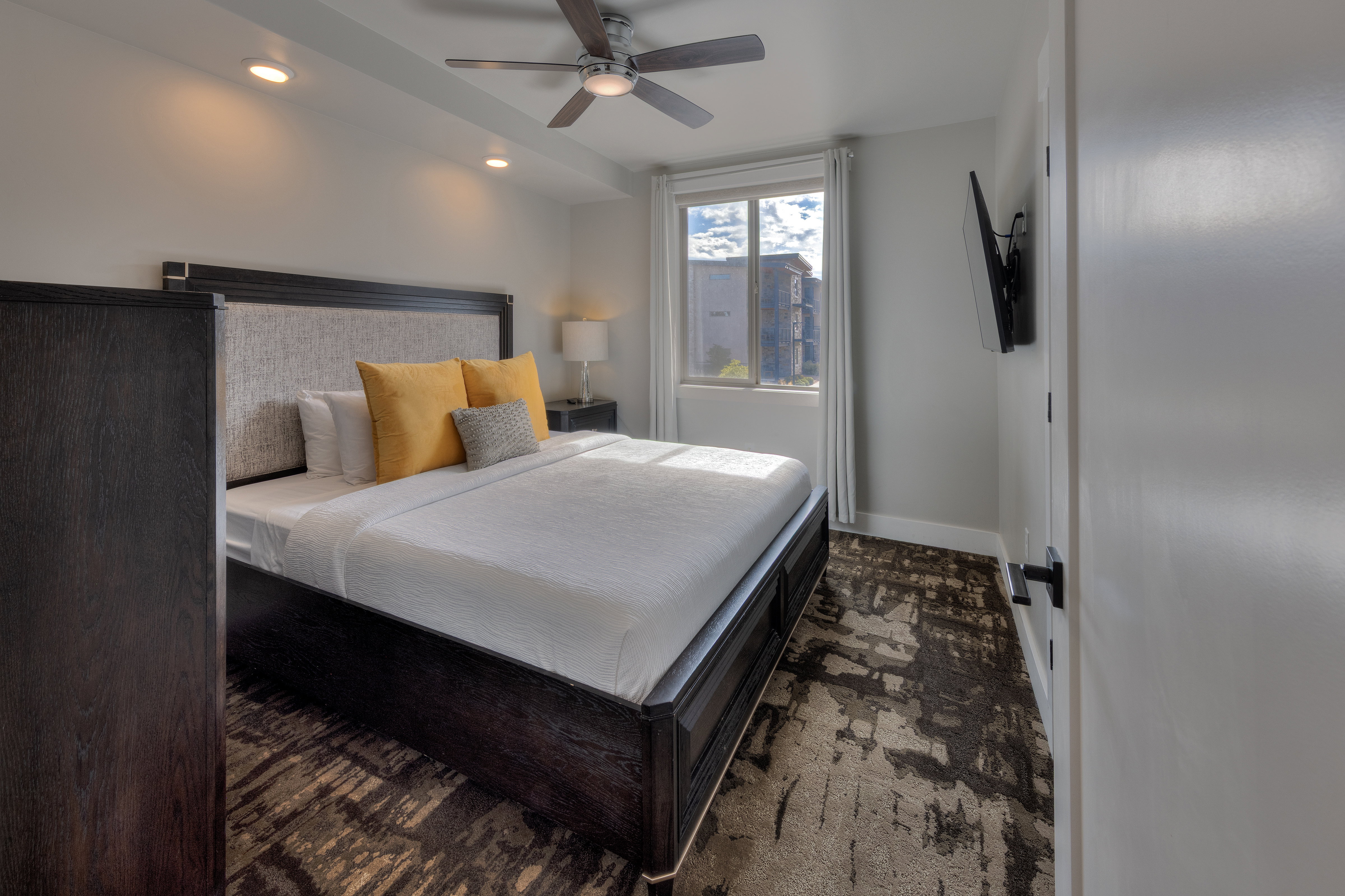 Bedroom featuring ceiling fan, recessed lighting, and dark colored carpet