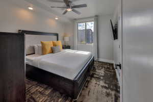 Bedroom featuring ceiling fan, recessed lighting, and dark colored carpet