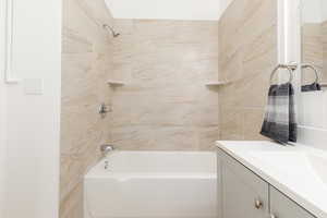 Bathroom featuring bathtub / shower combination and vanity