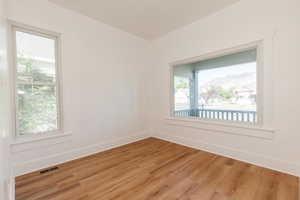Unfurnished room with baseboards and wood finished floors