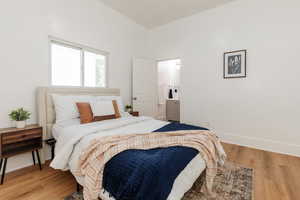 Bedroom featuring light wood-style floors and ensuite bathroom