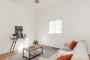 Living area with wood finished floors and ceiling fan