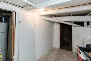 Unfinished below grade area featuring gas water heater
