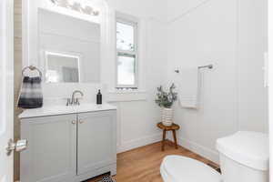 Half bathroom with vanity and light wood-style floors