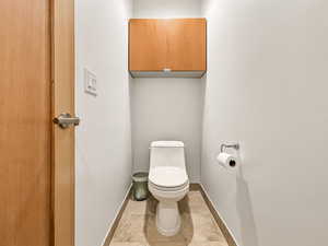 Bathroom with toilet and baseboards