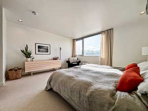Carpeted bedroom with recessed lighting and baseboards