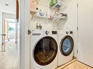 Laundry room featuring washer and dryer and tile patterned floors