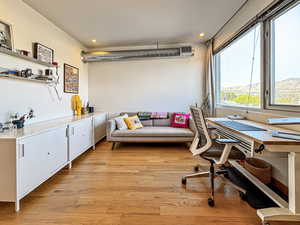 Office featuring light wood-style flooring and recessed lighting