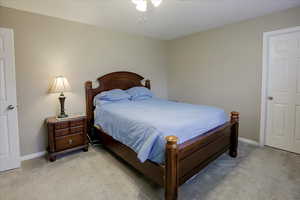 Bedroom with light carpet and ceiling fan