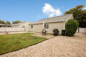 Back of house with a patio, a fenced backyard, and roof with shingles