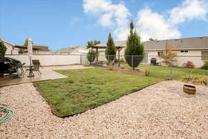 Fenced backyard with a patio area