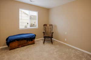 Living area with carpet floors and baseboards