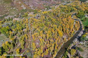 Aerial view of property and surrounding area with property parcel outlined