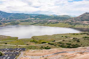 Aerial view of property's location with a water and mountain view