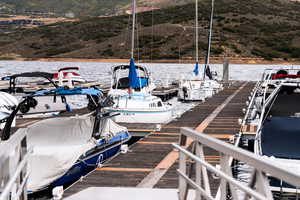 Dock area with a water and mountain view