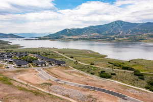 Aerial perspective of suburban area featuring a water and mountain view