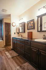 Primary suite bathroom  with large tub and separate shower.