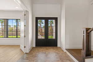 Entrance foyer with healthy amount of natural light, light wood finished floors, and recessed lighting