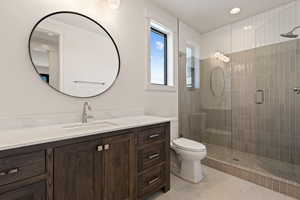 Full bath featuring a stall shower, vanity, light tile patterned floors, and recessed lighting