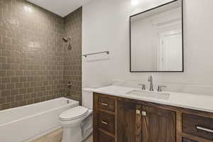 Bathroom featuring  shower combination, vanity, and light tile patterned floors