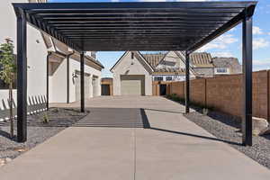 View of patio / terrace with a pergola and a garage