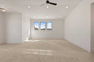 Empty room with recessed lighting and light carpet