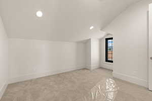Bonus room featuring lofted ceiling, light colored carpet, and recessed lighting