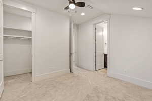 Unfurnished bedroom featuring light carpet, recessed lighting, a ceiling fan, and ensuite bath