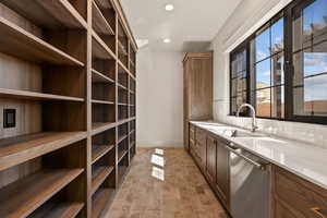 Wine room with recessed lighting and a sink