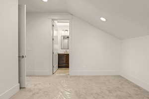 Bonus room with recessed lighting, lofted ceiling, and light carpet