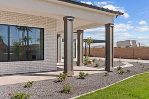Doorway to property with brick siding and covered porch