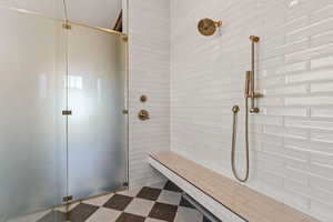 Bathroom with a shower stall and dark flooring
