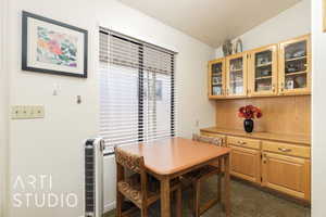 Dining space featuring a desk and lofted ceiling