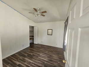 Unfurnished bedroom featuring dark wood-style flooring and ceiling fan