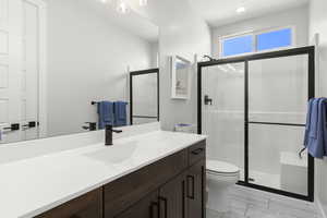 Bathroom featuring vanity and a stall shower